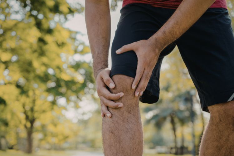 Sports chiropractor assessing a runner's knee at Equilibrium Family Wellness Indooroopilly